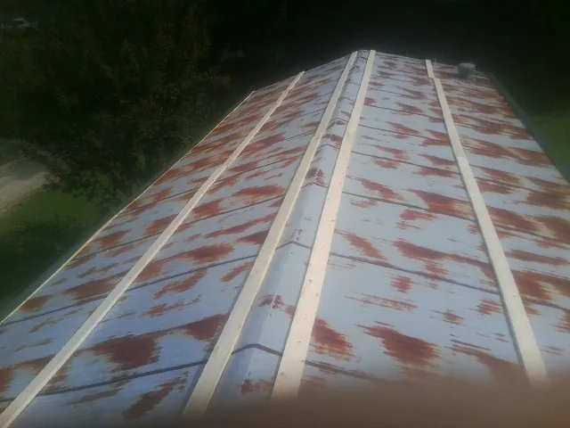 Rusted metal roof panels with new wood purlins before replacement — Storm Damage Roof Repair in Cornwall Bridge by Roofing Brothers